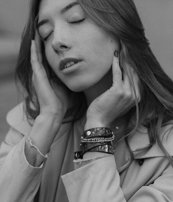 Calm person in a meditative pose with a serene expression.